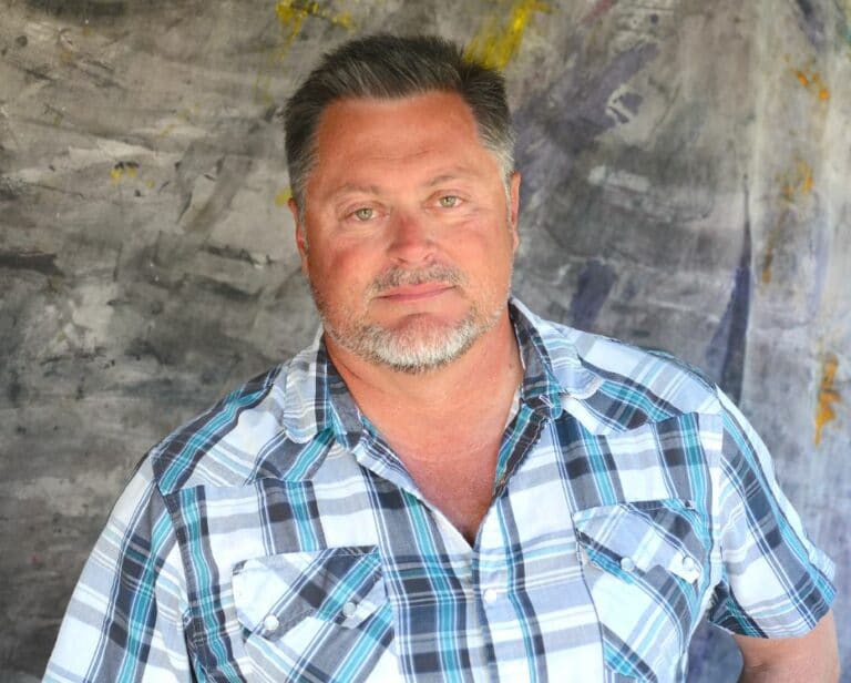 Chris Sayer in plaid shirt