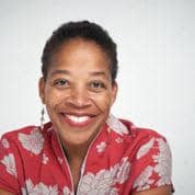 Nike Irvin smiling in front of white background