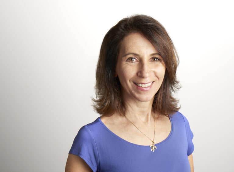Sarene Wallace in blue shirt in front of white background