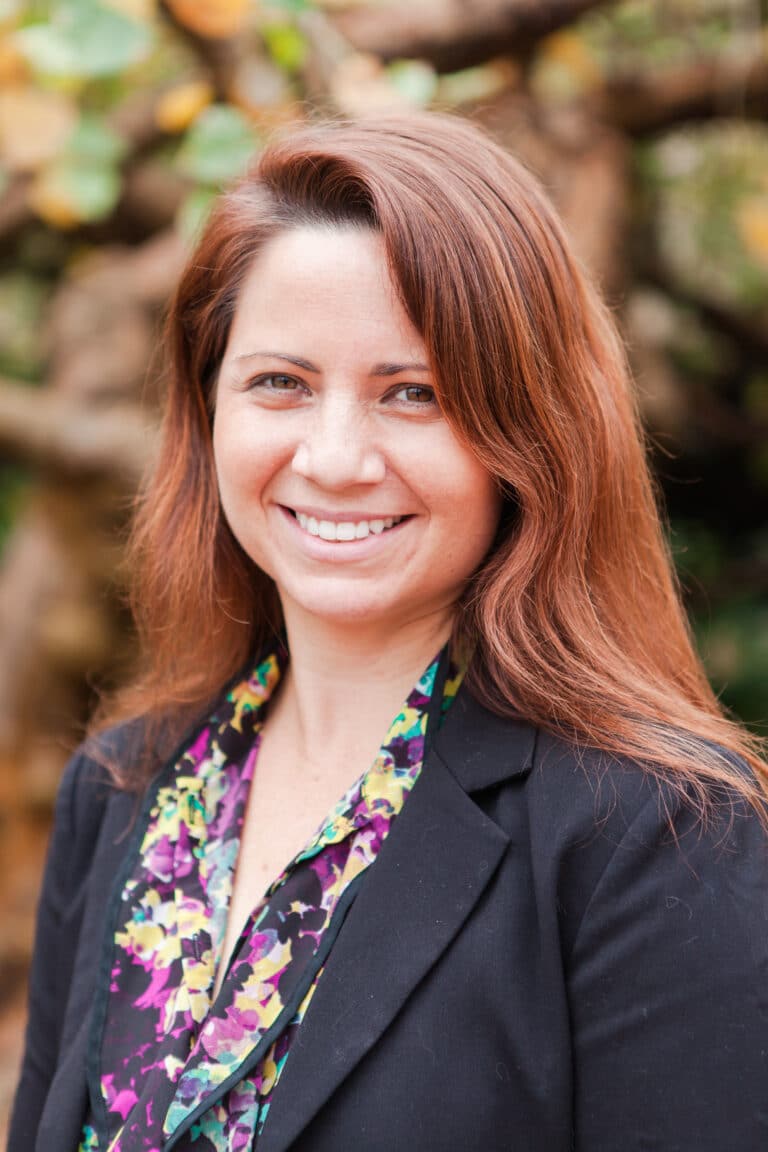 Tobie Mitchell smiling in suit