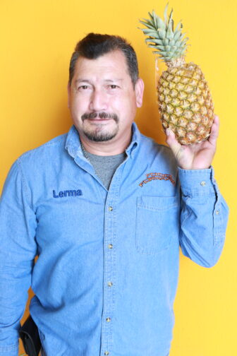 Manuel holding a pineapple