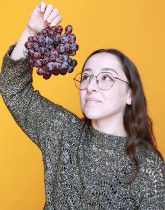 Kelsey holding grapes