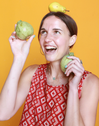 Jessie holding pears and balancing one on her head