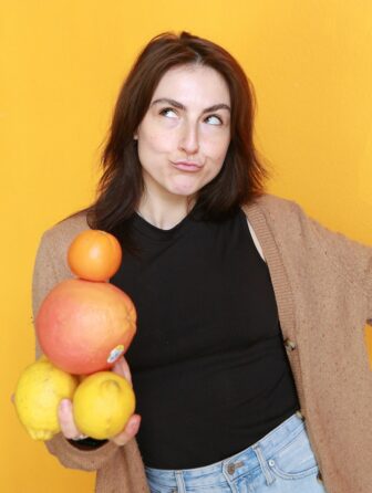 Alden holding a stack of citrus